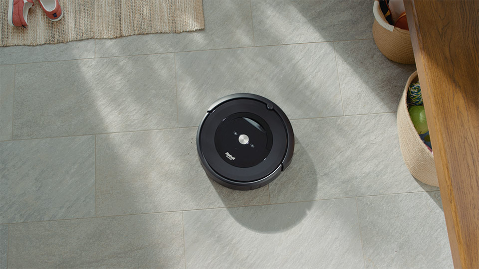 A iRobot Roomba i7 on a tile floor.