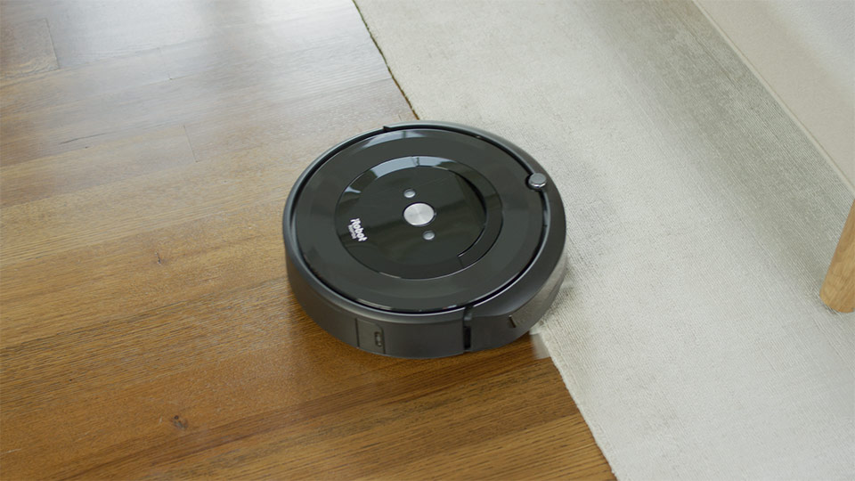 A iRobot Roomba i7 on a carpet.