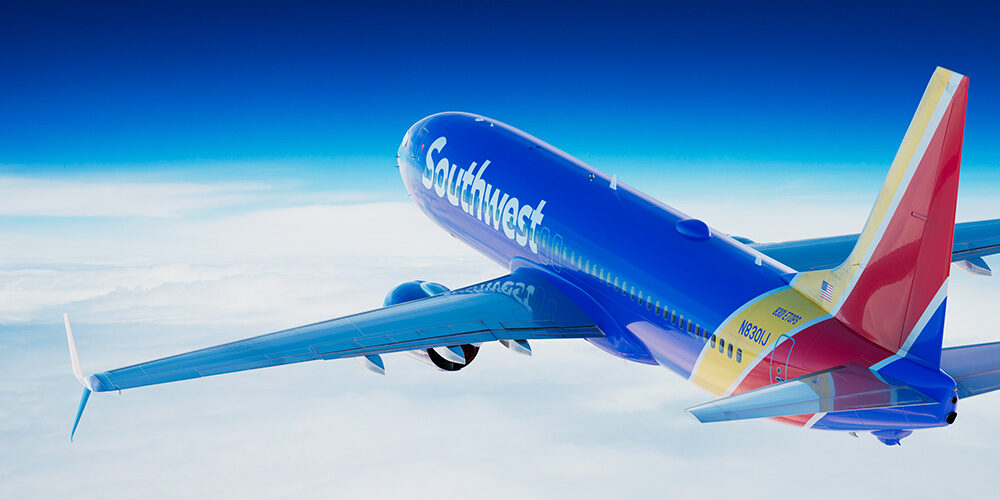 A render of a Southwest Airlines aircraft flying above the clouds.