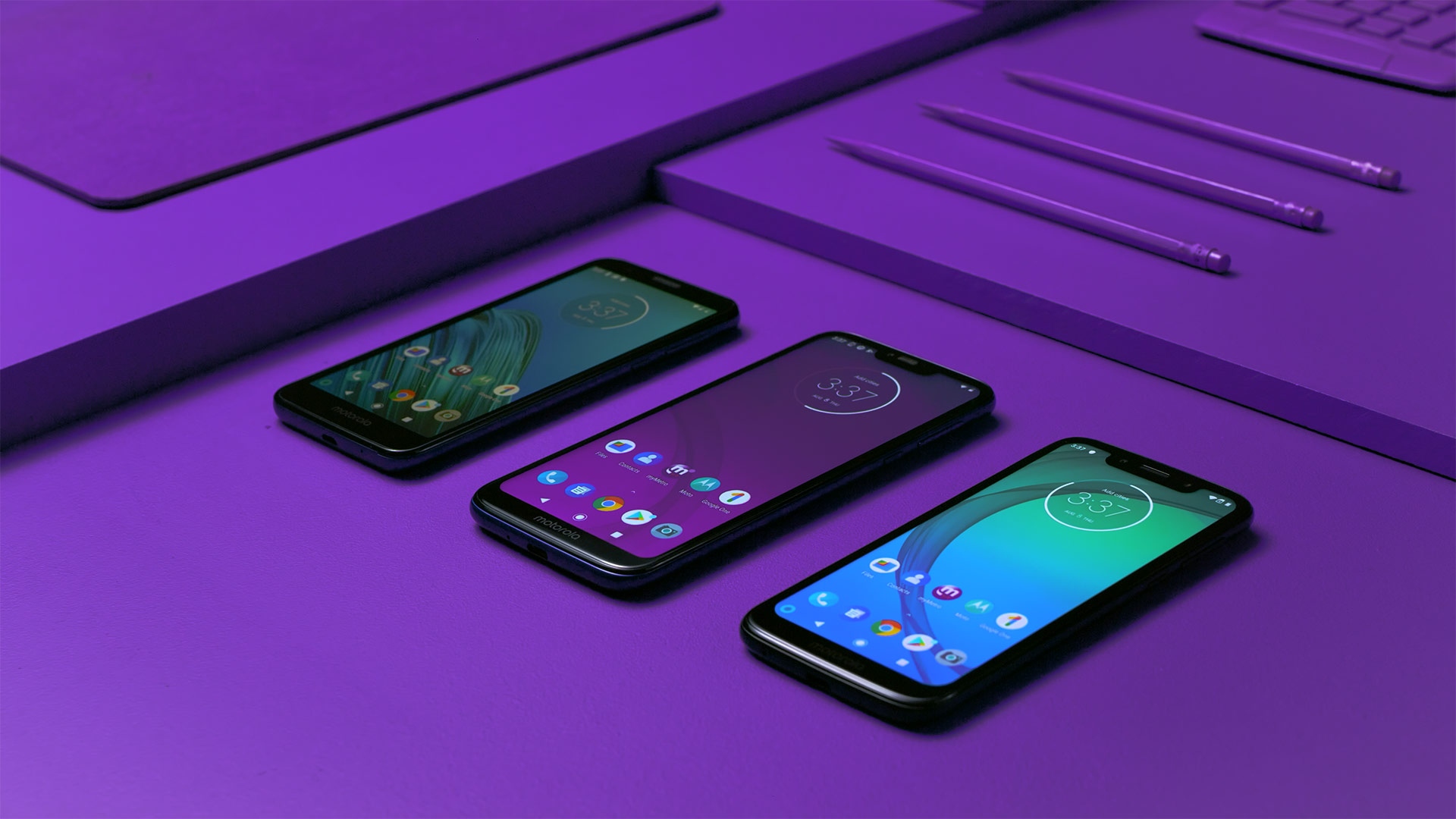 A n art directed shot of smartphones on a bright purple background.