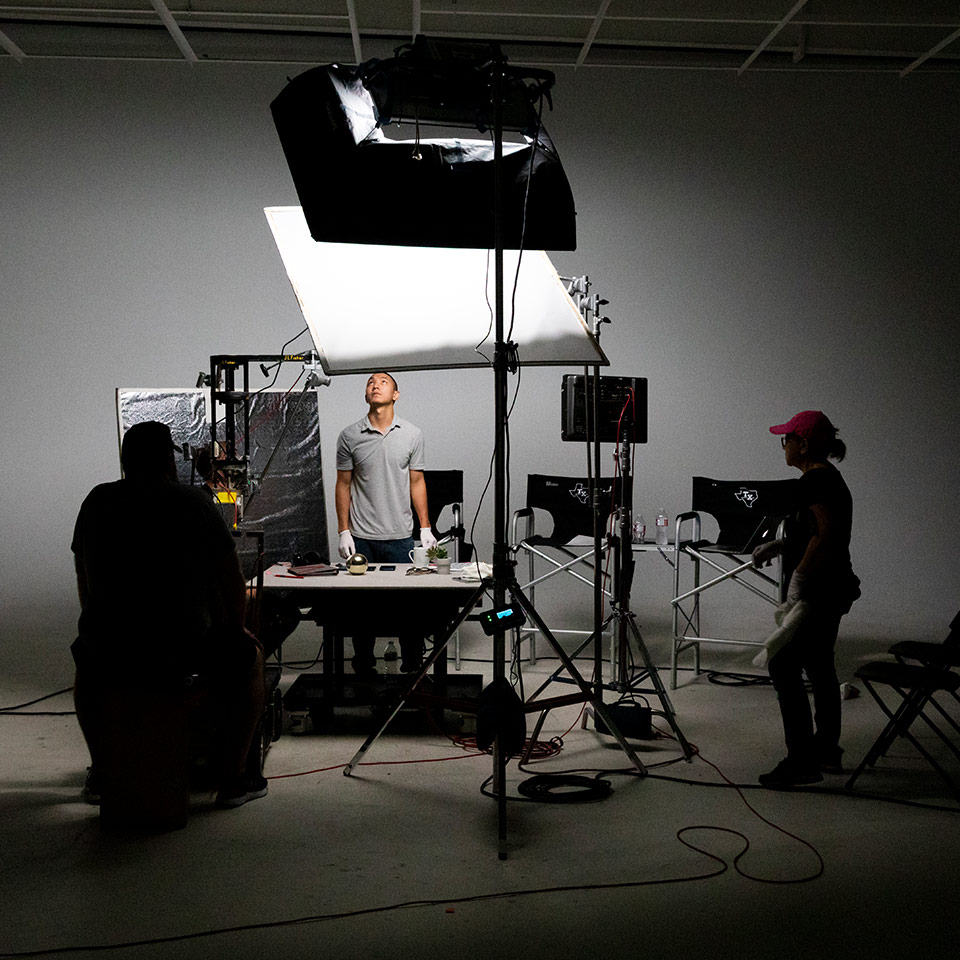A behind the scenes photo of a tabletop studio commercial shoot.