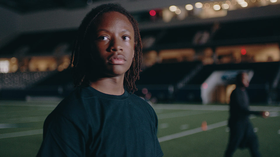 An athlete looks off camera while practicing at the Dallas Cowboys practice stadium.