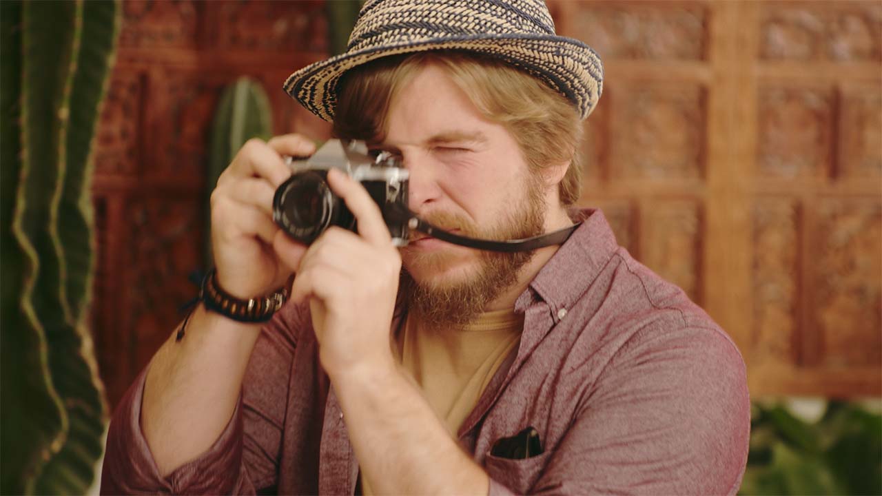 A man using a analog film camera.