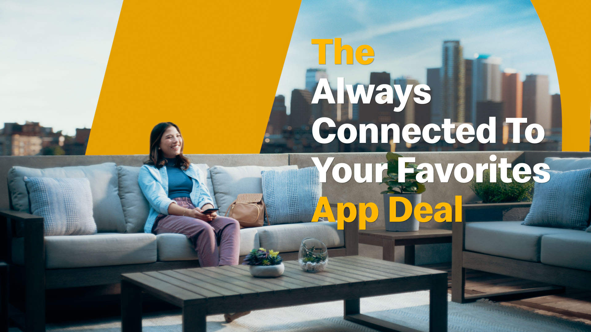 A woman sitting on a rooftop patio with a McDonald's arch extending behind her. The text "The always connected to your favorites app deal" is superimposed.